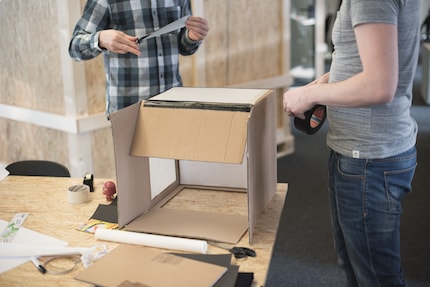 You can also paint the brown areas of the cardboard with a white spray.
