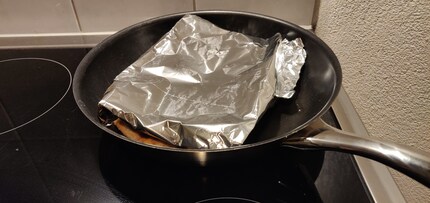 A solid lid: Tin foil is perfectly suited to bring your pizza to the perfect temperature.