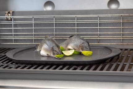 The two small chars sit on top of half and are placed on the grill.