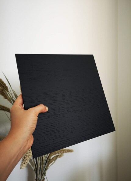 The black oak veneer tray adds refinement to the metal frame.