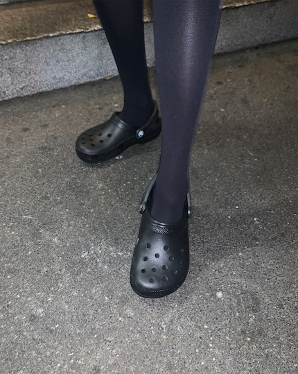 Black stockings in Crocs.
