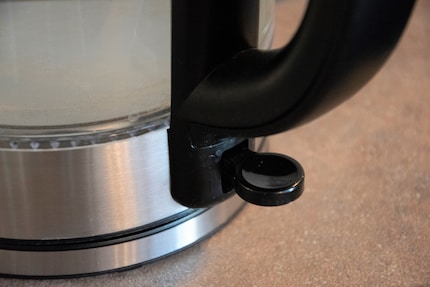 The button for switching on is located under the handle