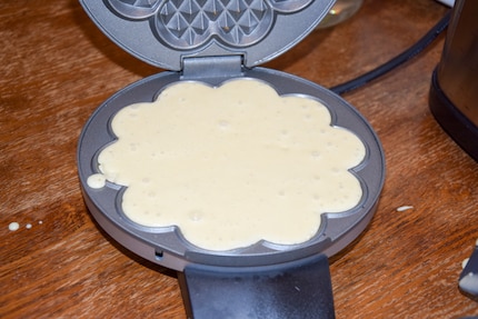 About two tablespoons of batter are needed per waffle.