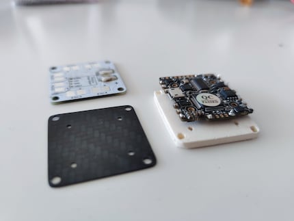 Prototype of the wooden adapter and the final carbon version