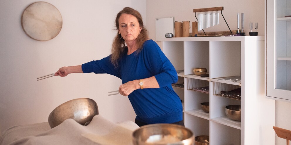 Christine waving the tuning forks.