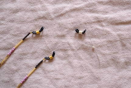 A knot is suitable for a nylon thread and a crimp bead for a wire fastener.
