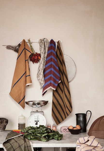 They're also decorative: the linens hanging on the wall. Photo: Ferm Living