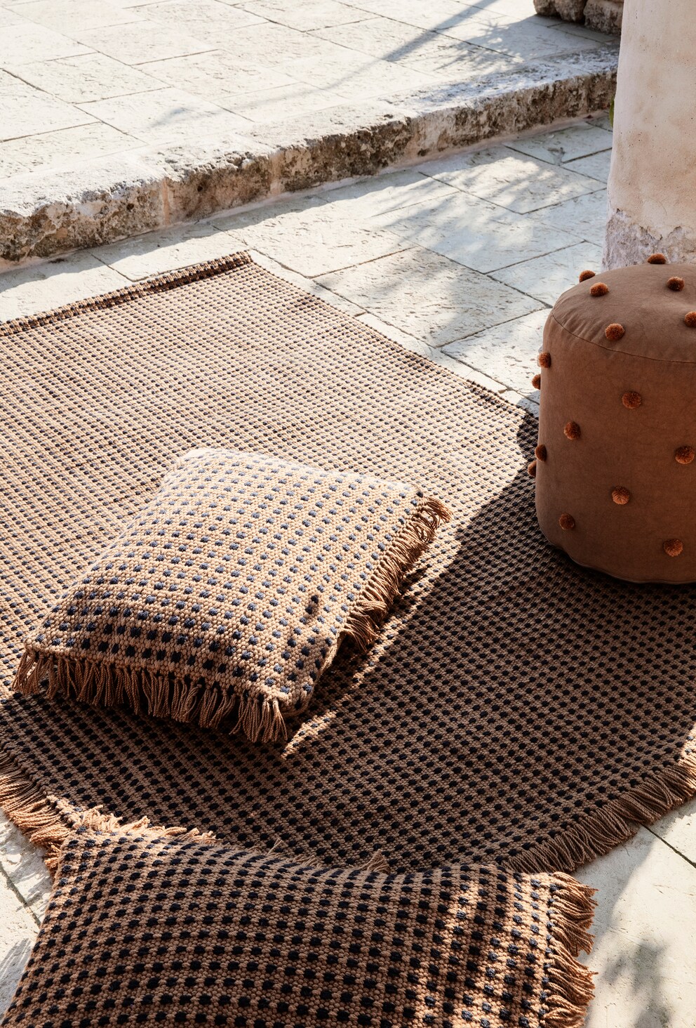 An outdoor carpet and cushions provide comfort on the terrace.  Image: Ferm Living
