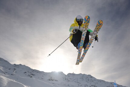 Freestylers fly over the slopes on wide skis.