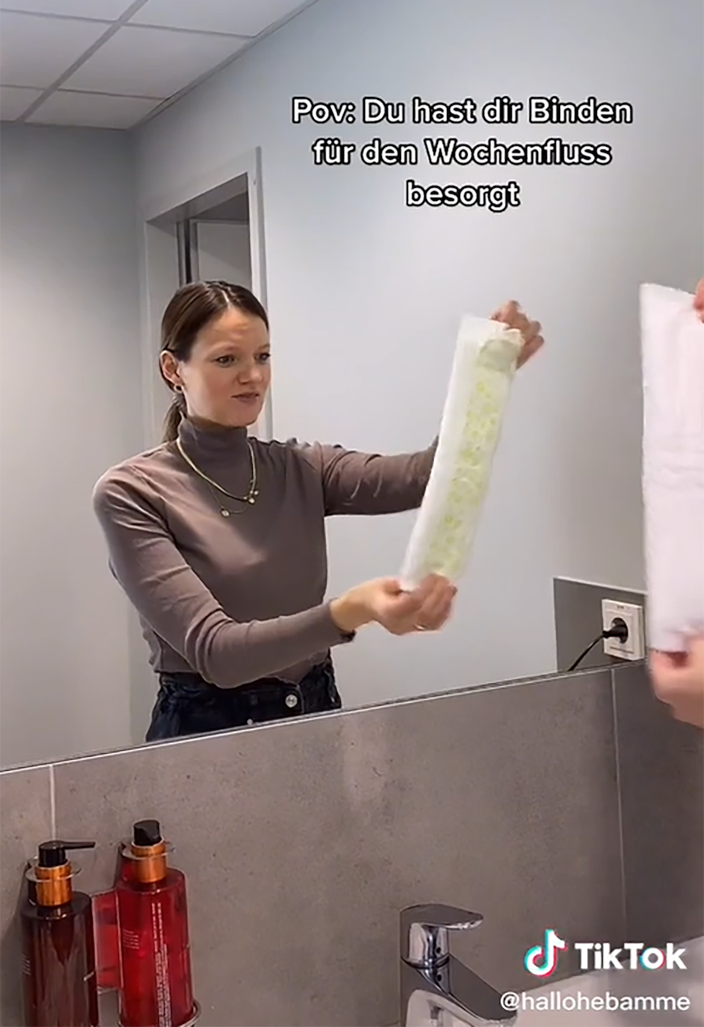 Rare social media entry: a midwife presents an oversized postpartum sanitary pad.