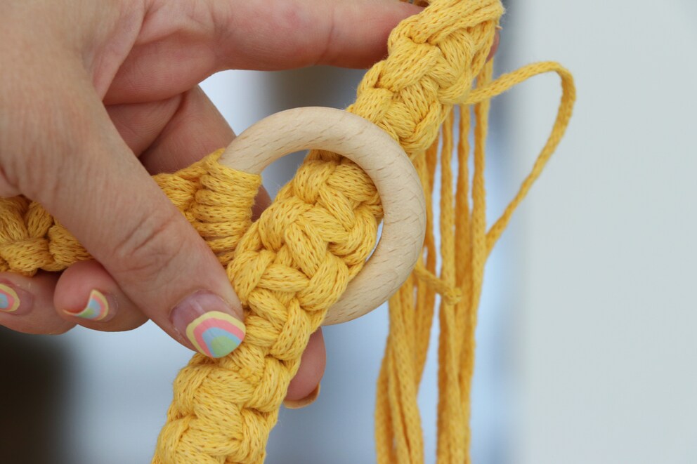 Once through the wooden ring.