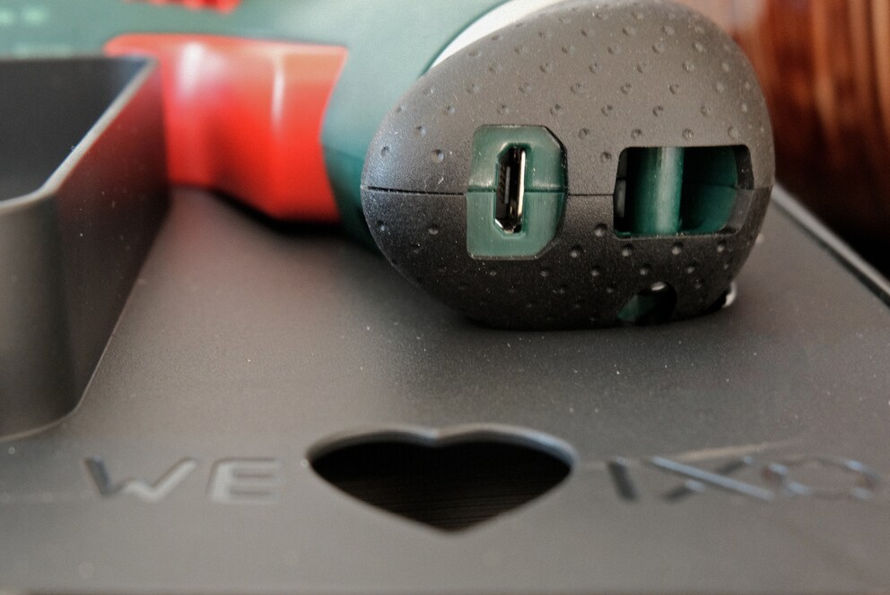 Stecke den Micro-USB-Stecker direkt in die Maschine und fädle das Kabel durch das Herz nach aussen.