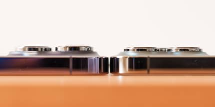 The camera bump on the iPhone 14 Pro (left) protrudes more than that on the 13 Pro (right). FYI: the latter has a screen protector on it, which is why it’s slightly more elevated here.