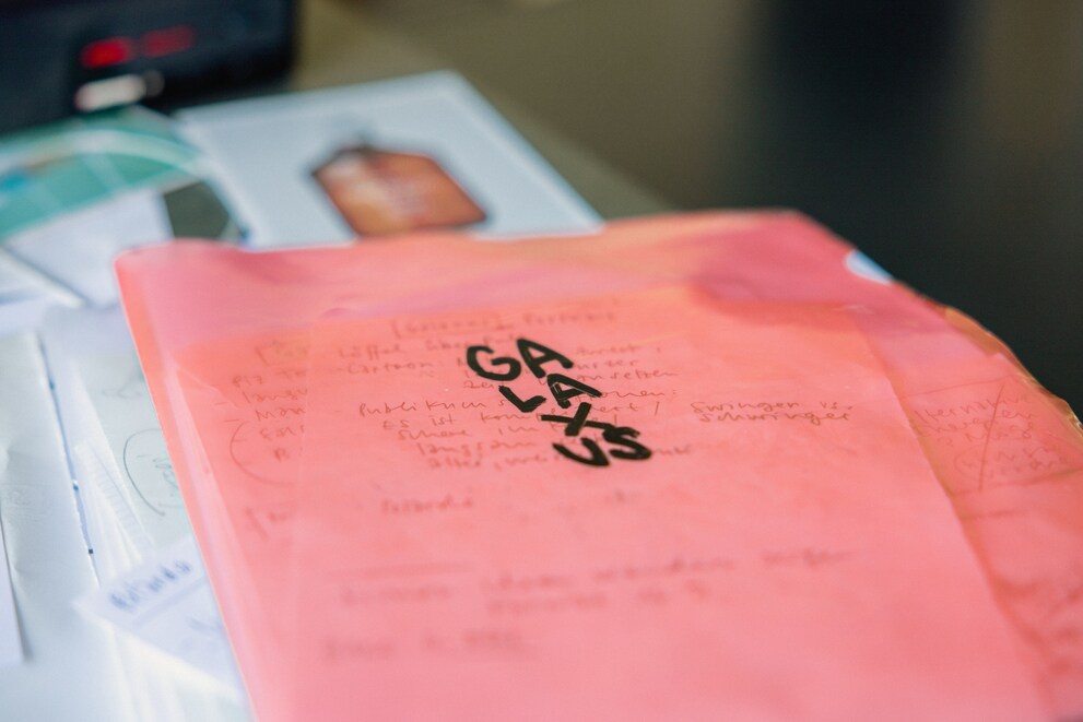 Loose pages containing ideas and sketches are bundled up in a folder.