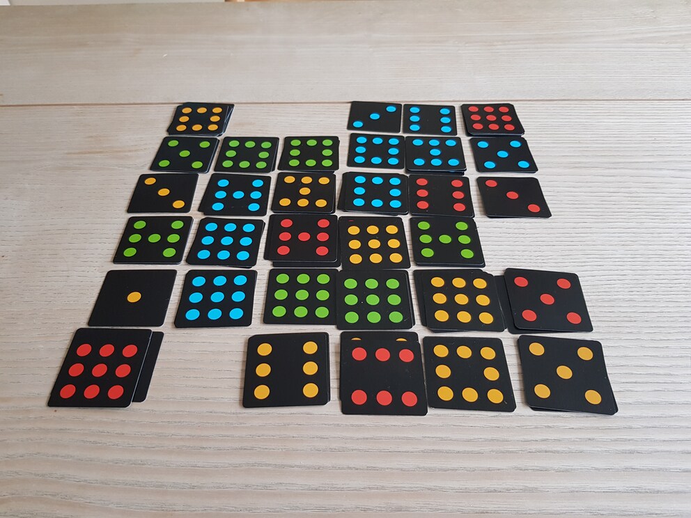 We’ve laid all the cards. The game is over. Because neither of us got five in a row, my daughter wins with the only yellow four in a row.