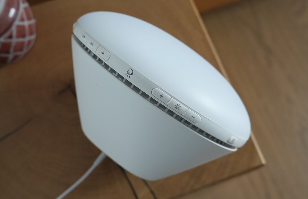The buttons are small and awkwardly located on the edge of the alarm clock.