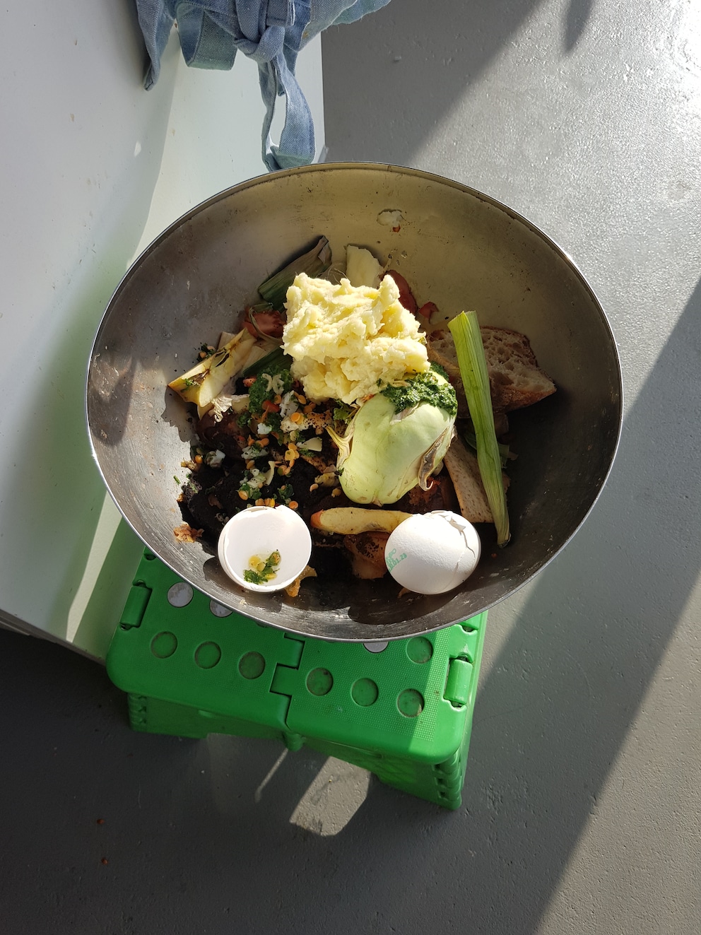 La ciotola per il compost è a soli tre passi dal lavandino, ma è già troppo lontana per me.