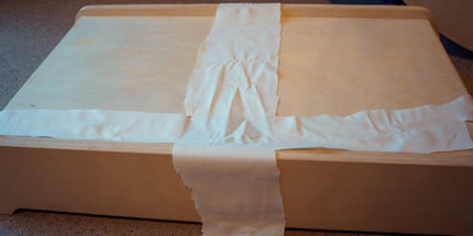 Step 1: cut fabric and lay it out on the frame.