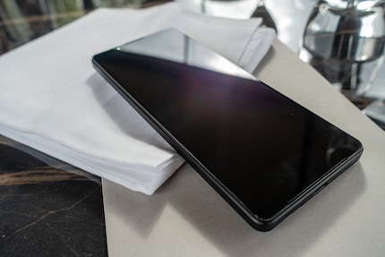 The speaker slots are located on the front of the display.