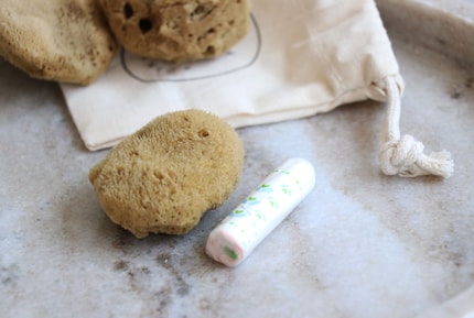 A size S sponge next to a regular-absorbency tampon.