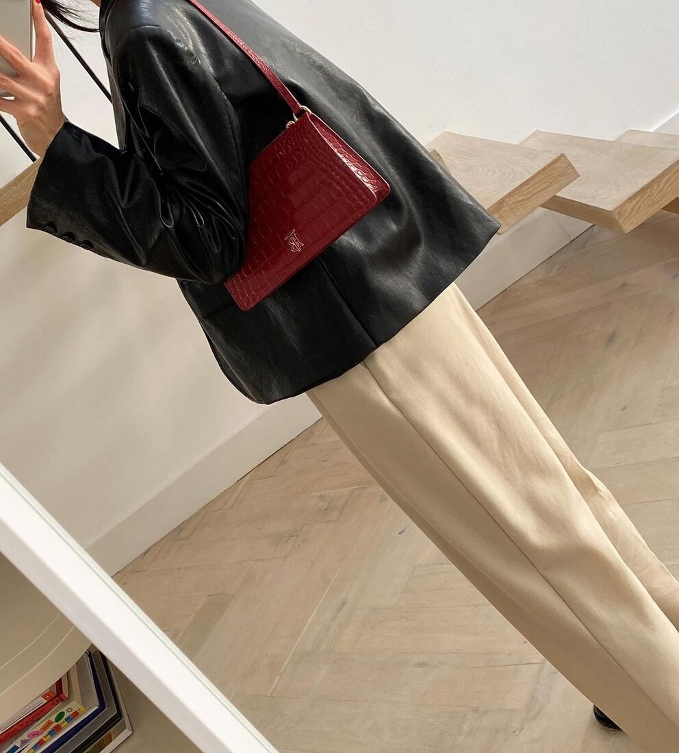 The dark red bag brings in a pop of excitement without looking jarring.