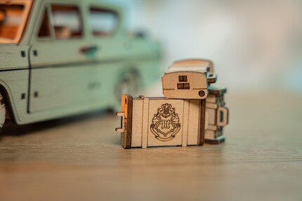 One of the three suitcases has the Hogwarts logo engraved on it.