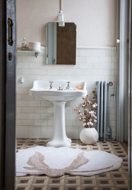 Flower Power: The round floral rug even shakes up a dusty and stiff tile pattern.