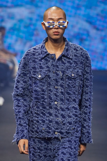 Die losen Fäden der Jeansjacke aus der Frühlingskollektion 24 von Bludiblu kreieren die Illusion eines Hahnentrittmusters.
