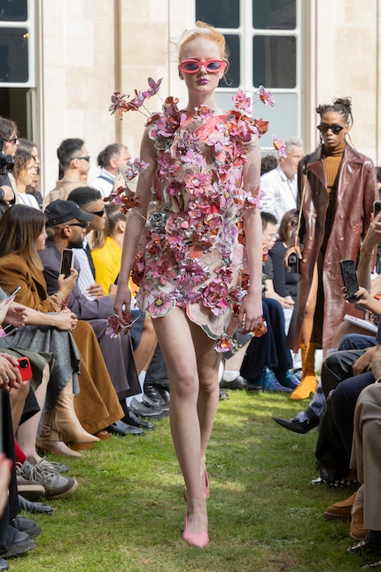 This dress from Marni's spring 24 collection consists of a kind of paper collage that has been enhanced with 3D flowers