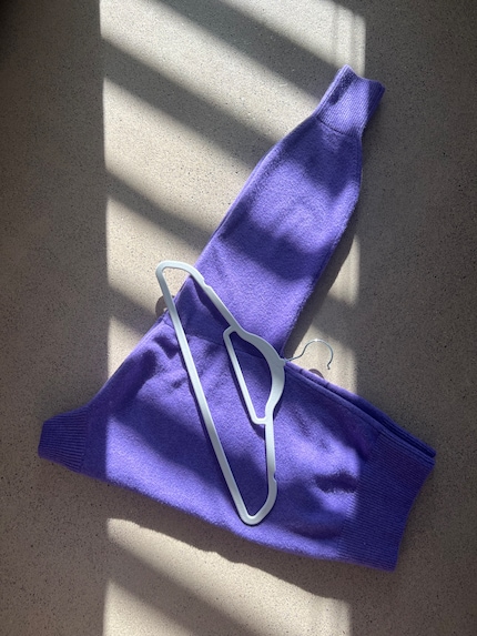 Fold your jumper in half and place your hanger on top.