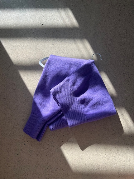  Then fold the sleeves and the bottom part of the garment over the hanger. Now the weight is evenly distributed.