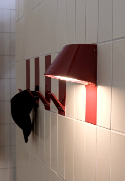 Here, not only tiles are brought to the wall, but also ceramic lamps and hooks.