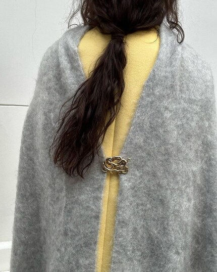 Nice detail: pin the ends of the scarf together at the back with a brooch.