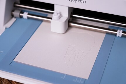 The AT-AT Christmas card in the Cricut with the card cutting mat.