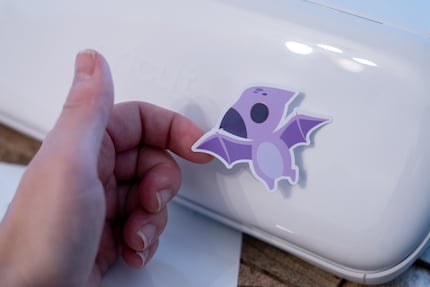 The colourful dinosaur fits perfectly on the boring-looking, white Cricut Joy Xtra.