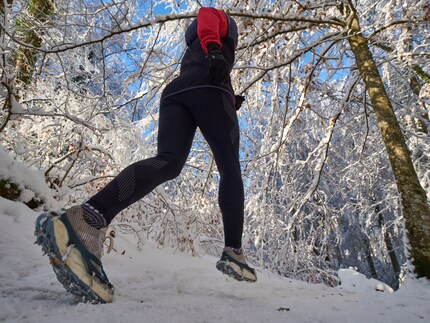 Thanks to the spikes, I can walk safely through the snowy winter forest.
