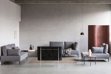 Simple metal TV stands highlight the screen.