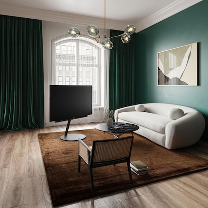 Because the plain black stand runs diagonally and the cables are hidden, it looks like the TV’s floating.