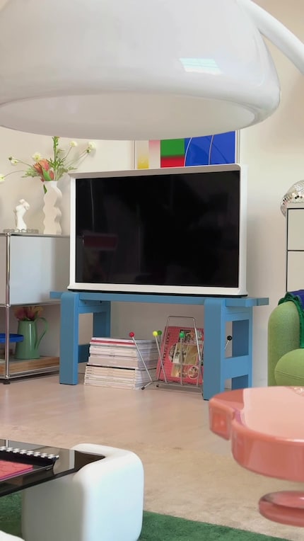 TV screens can look more soft and playful when paired with colourful or organically shaped furniture.