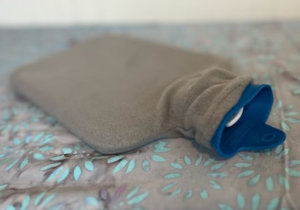 You can’t really go wrong with an inexpensive hot water bottle that’s filled with water.