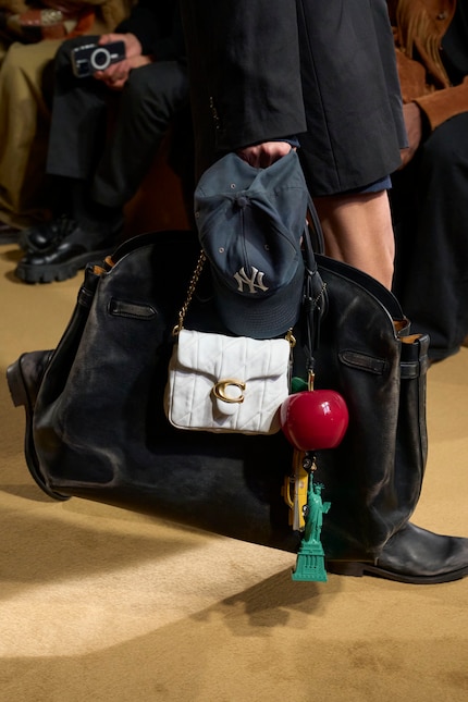 Cap, small bag, large bag - the Coach model has her hands full.