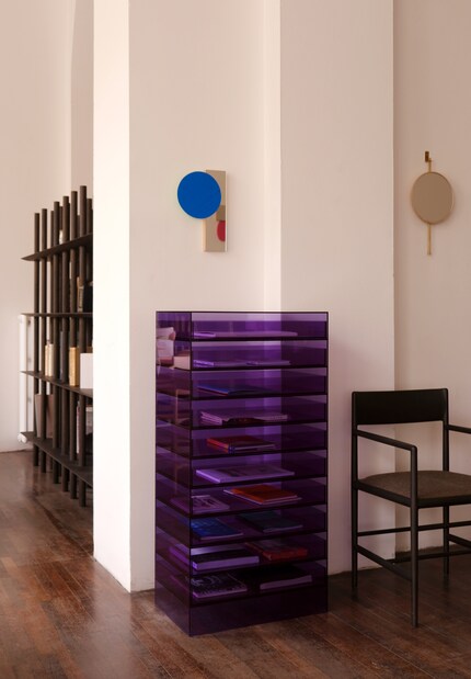 The vibrant blue of the Objewellery mirror series by Yurina Kira decorates the room.