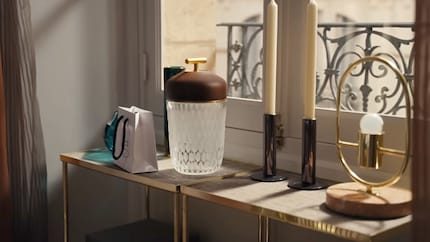 Instead of folders and paper documents, the console tables stage candlesticks and lamps. 