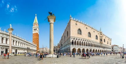 Place Saint-Marc avec le Campanile et le Palais des Doges | Le lion se trouve sur l'une des deux colonnes de la partie de la place Saint-Marc située près de la rive, appelée Piazzetta San Marco. Le lion ailé, qui se trouve également sur les armoiries de la ville, représente l'évangéliste Marc. La statue sur la deuxième colonne représente Théodore, le deuxième saint de la ville.