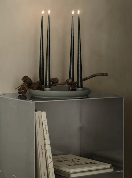 Sitting in a tray, the candles can be decorated with greenery...