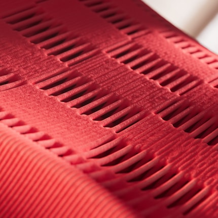 Different textures and densities of the material characterise the shoe.