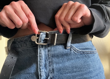 Insert the pin through the buttonhole, …