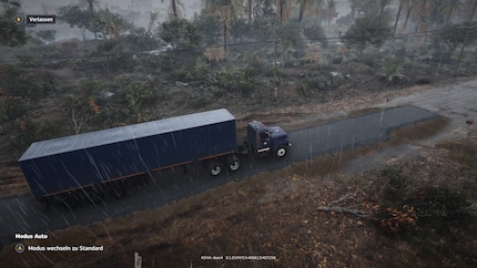 A truck driving on a freshly tarred road.