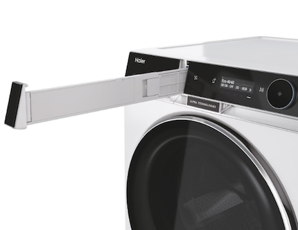 The fluff filter is located directly next to the control panel on the washer-dryer.